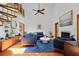 Open living room with high ceilings, fireplace, modern furnishings, and spiral staircase at 8554 Amber Oak Dr, Orlando, FL 32817