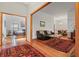 Open-concept living room showcasing hardwood floors, a cozy seating area, and ample natural light at 8554 Amber Oak Dr, Orlando, FL 32817