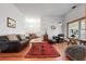 Spacious living room featuring hardwood floors, comfortable seating, and an adjacent dining area at 8554 Amber Oak Dr, Orlando, FL 32817