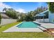 A backyard featuring a pristine pool with a spacious patio, and a manicured lawn at 8554 Amber Oak Dr, Orlando, FL 32817