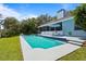 Inviting backyard pool with a well-maintained lawn, patio, and a screened lanai for relaxing and entertaining at 8554 Amber Oak Dr, Orlando, FL 32817