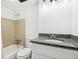 Updated bathroom featuring a granite vanity top, tiled shower, and modern fixtures at 935 S Atlantic Ave # 302, Daytona Beach, FL 32118