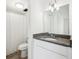 Neutral bathroom featuring granite countertop, a white vanity, and shower at 935 S Atlantic Ave # 302, Daytona Beach, FL 32118