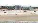 View from the beach showing the condo building's access to the beach and the nearby ocean, a perfect vacation spot at 935 S Atlantic Ave # 302, Daytona Beach, FL 32118