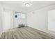 Bright bedroom with neutral walls, wood-look flooring, and a comfortable space at 935 S Atlantic Ave # 302, Daytona Beach, FL 32118