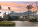 Stunning exterior view of Ocean Jewels Club with lush landscaping and palm trees at 935 S Atlantic Ave # 302, Daytona Beach, FL 32118