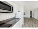 Well-equipped kitchen featuring granite countertops, white cabinets, and stainless steel microwave at 935 S Atlantic Ave # 302, Daytona Beach, FL 32118