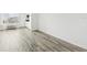 Open concept living area featuring wood-look flooring, and updated kitchen access at 935 S Atlantic Ave # 302, Daytona Beach, FL 32118