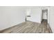 Neutral living area with wood-look flooring, neutral paint, and bathroom access at 935 S Atlantic Ave # 302, Daytona Beach, FL 32118