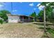 This cozy backyard features a screened in porch, white exterior, and lawn at 944 Essex Rd, Daytona Beach, FL 32117