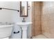 Bathroom features a pedestal sink, toilet, and tiled shower at 944 Essex Rd, Daytona Beach, FL 32117