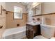 Bathroom features a shower-tub combo with a vanity, toilet, and medicine cabinet at 944 Essex Rd, Daytona Beach, FL 32117