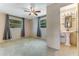 Bright main bedroom with two windows and an ensuite bathroom with a sink at 944 Essex Rd, Daytona Beach, FL 32117