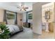 Stylish main bedroom with two large windows and an ensuite bathroom at 944 Essex Rd, Daytona Beach, FL 32117