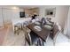 Dining area with a wooden table set for six, adjacent to the kitchen at 103 Orchid Ct, Poinciana, FL 34759