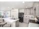 Modern kitchen with granite countertops, stainless steel appliances, and a breakfast bar at 103 Orchid Ct, Poinciana, FL 34759