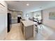 Spacious kitchen with a large island and modern appliances, seamlessly connected to the dining area at 103 Orchid Ct, Poinciana, FL 34759