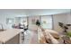 Open living space with a view of the dining area and a sliding glass door to the outdoor space at 103 Orchid Ct, Poinciana, FL 34759
