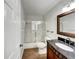 Traditional bathroom features a vanity with black countertop and shower with glass doors at 10350 Sw 62Nd Terrace Rd, Ocala, FL 34476