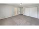 Bedroom showcasing neutral walls, plush carpet, and double door closet at 10350 Sw 62Nd Terrace Rd, Ocala, FL 34476