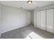 Empty bedroom featuring neutral walls, plush carpet, and double door closet at 10350 Sw 62Nd Terrace Rd, Ocala, FL 34476