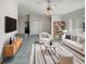Bright living room boasts stylish furniture, tile flooring, and a contemporary ceiling fan at 10350 Sw 62Nd Terrace Rd, Ocala, FL 34476