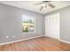 This spacious bedroom features wood floors, a ceiling fan, a window and a closet at 109 Long Leaf Pine Cir, Sanford, FL 32773