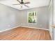 Bright bedroom with wood-look flooring, a ceiling fan, and large window at 109 Long Leaf Pine Cir, Sanford, FL 32773