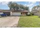 Charming single-story home with a well-maintained lawn, driveway, and attached garage at 109 Long Leaf Pine Cir, Sanford, FL 32773