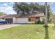 Single-story home with an attached garage, driveway, lawn, and front entry area with greenery at 109 Long Leaf Pine Cir, Sanford, FL 32773