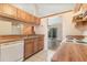 Cozy kitchen with wood cabinetry, laminate countertops, and view to the living area at 109 Long Leaf Pine Cir, Sanford, FL 32773