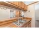 Kitchen with stainless steel sink, wood cabinets and laminate countertops at 109 Long Leaf Pine Cir, Sanford, FL 32773