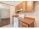 Kitchen with white appliances, wood cabinets and laminate countertops at 109 Long Leaf Pine Cir, Sanford, FL 32773