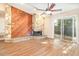Spacious living room with a stone fireplace, wood wall and sliding glass door at 109 Long Leaf Pine Cir, Sanford, FL 32773