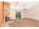 Open living room boasts hardwood floors, a stone fireplace, and access to the outdoors at 109 Long Leaf Pine Cir, Sanford, FL 32773