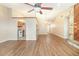 Open-concept living room with wood-look flooring, neutral walls, and a unique stone fireplace at 109 Long Leaf Pine Cir, Sanford, FL 32773