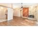 Open living room with hardwood flooring, fireplace and view to kitchen area at 109 Long Leaf Pine Cir, Sanford, FL 32773