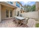 Outdoor dining area on brick patio with lights strung overhead, great for backyard entertaining at 11213 Grander Dr, Windermere, FL 34786