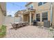 Beautiful outdoor brick patio with dining area and BBQ, with string lights and a privacy fence at 11213 Grander Dr, Windermere, FL 34786