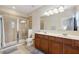 Bathroom features a glass-enclosed shower, double sink vanity, and neutral tile; a spa-like retreat at 11213 Grander Dr, Windermere, FL 34786