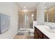 Well-lit bathroom with glass-enclosed shower and single sink vanity, offering comfort and functionality at 11213 Grander Dr, Windermere, FL 34786