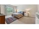Bright bedroom featuring a large window, carpeted floor, and ample space at 11213 Grander Dr, Windermere, FL 34786