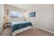 Bright bedroom featuring a comfortable bed, large window, and tasteful decor; a tranquil escape at 11213 Grander Dr, Windermere, FL 34786