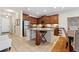 Open kitchen featuring an island with granite countertops and stainless steel refrigerator at 11213 Grander Dr, Windermere, FL 34786