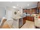 Open kitchen with granite countertops, stainless steel appliances, and adjacent dining area at 11213 Grander Dr, Windermere, FL 34786
