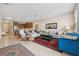 Open-concept living area with cozy seating, a modern mirror, and adjacent dining area at 11213 Grander Dr, Windermere, FL 34786