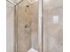 Shower with glass doors, tiled walls, shower head and neutral tones for a clean and modern look at 11213 Grander Dr, Windermere, FL 34786