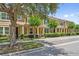 Townhome with a landscaped yard and mature trees along a well-maintained street at 11213 Grander Dr, Windermere, FL 34786