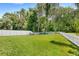 Large grassy backyard enclosed by a white picket fence, perfect for outdoor activities at 11225 Cypress Trail Dr, Orlando, FL 32825