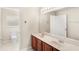 Bathroom with double sinks, a large mirror and tiled floors at 11225 Cypress Trail Dr, Orlando, FL 32825